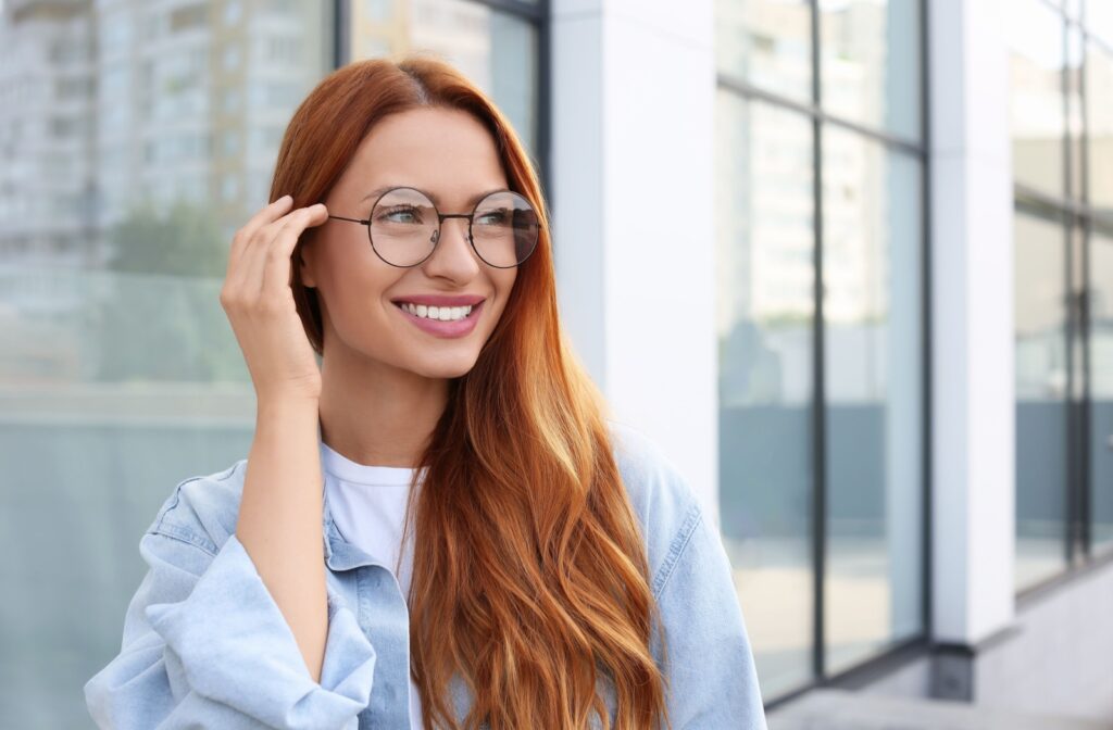 Person with a square face wearing round framed glasses.